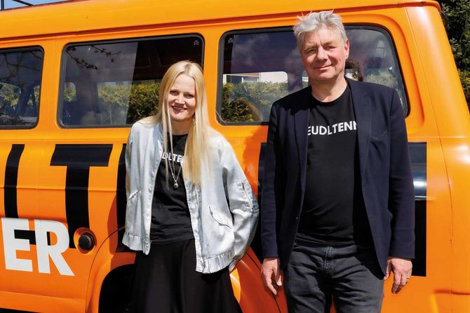 Hakon Hirzenberger und Bernadette Abendstein vom Steudltenn Festival vor orangem Bus