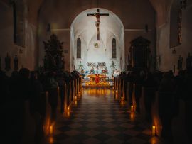 Mit Kerzenschein beleuchtete Kirche beim Adventskonzert in Imst.